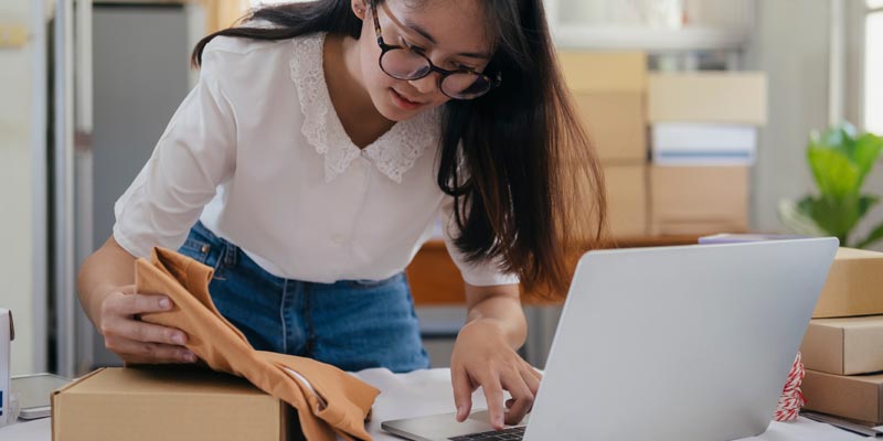 woman packing ecommerce orders